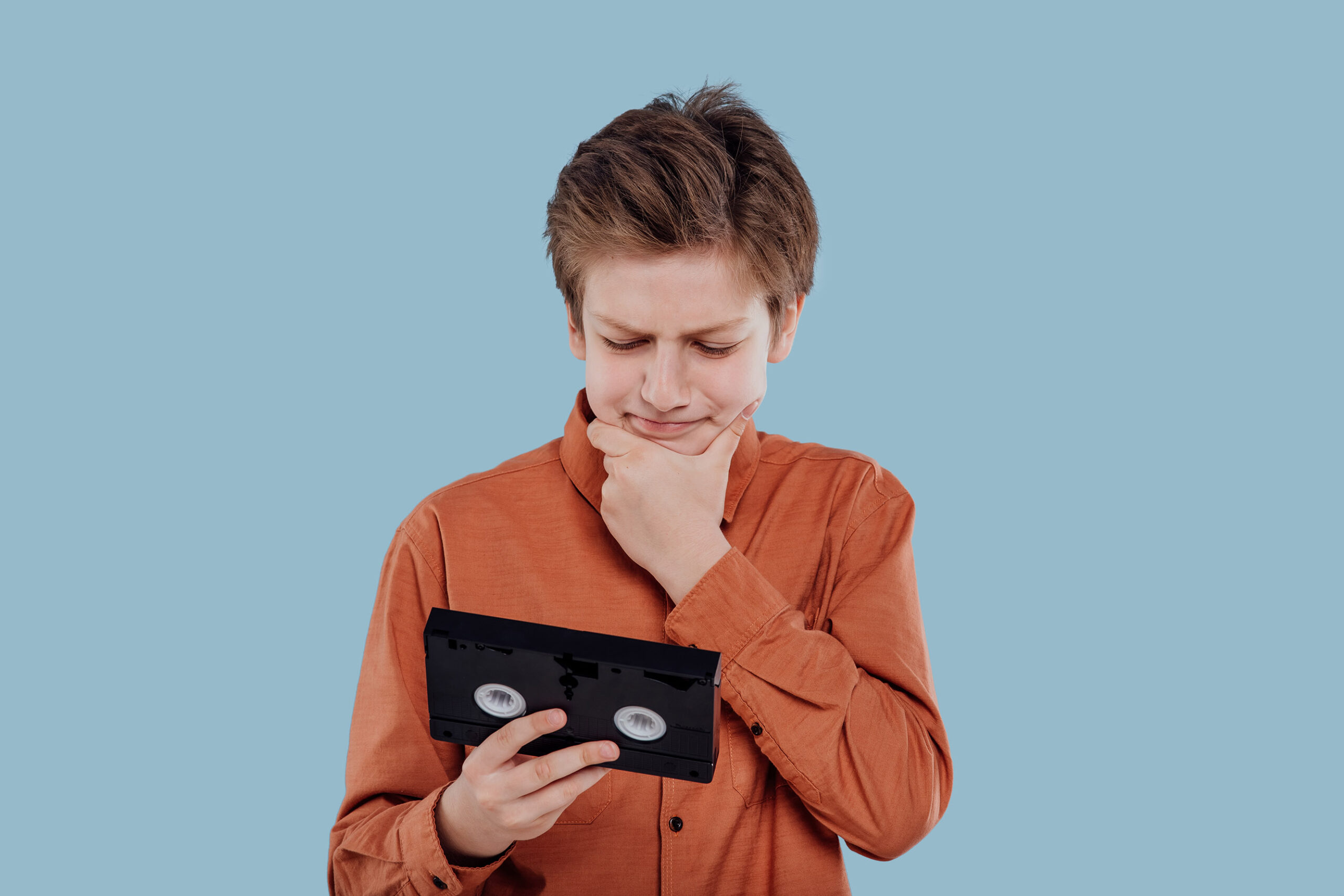 amazed preteen with video tape,